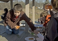 Christopher climbs across dining table