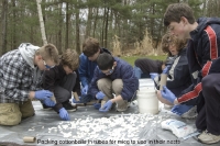 Scouts stuff cotton-balls into tubes